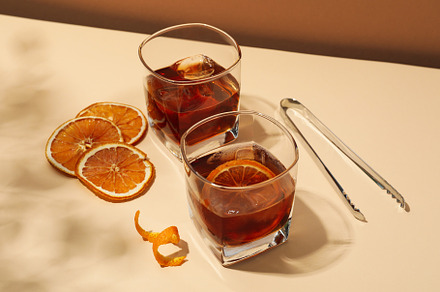 Concept of delicious alcohol drink, Whiskey with orange, a Food & Drink Photo by AtlasStudio PRO