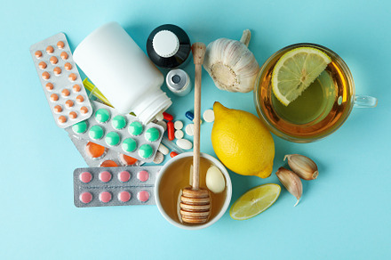 Concept of treatment colds with honey and garlic on blue backgro, a Food & Drink Photo by AtlasStudio