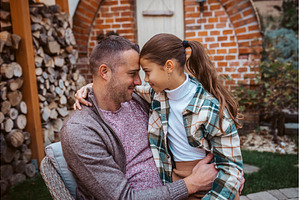 Father touching forehead with, a Person Photo by HalfPoint
