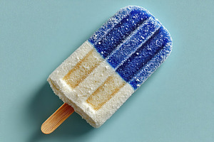 Blue, white, and yellow frosty popsicle on textured light blue b, a Holiday Photo by José Manuel Gelpi