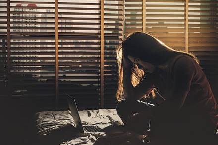 depressed Women sitting head in hand