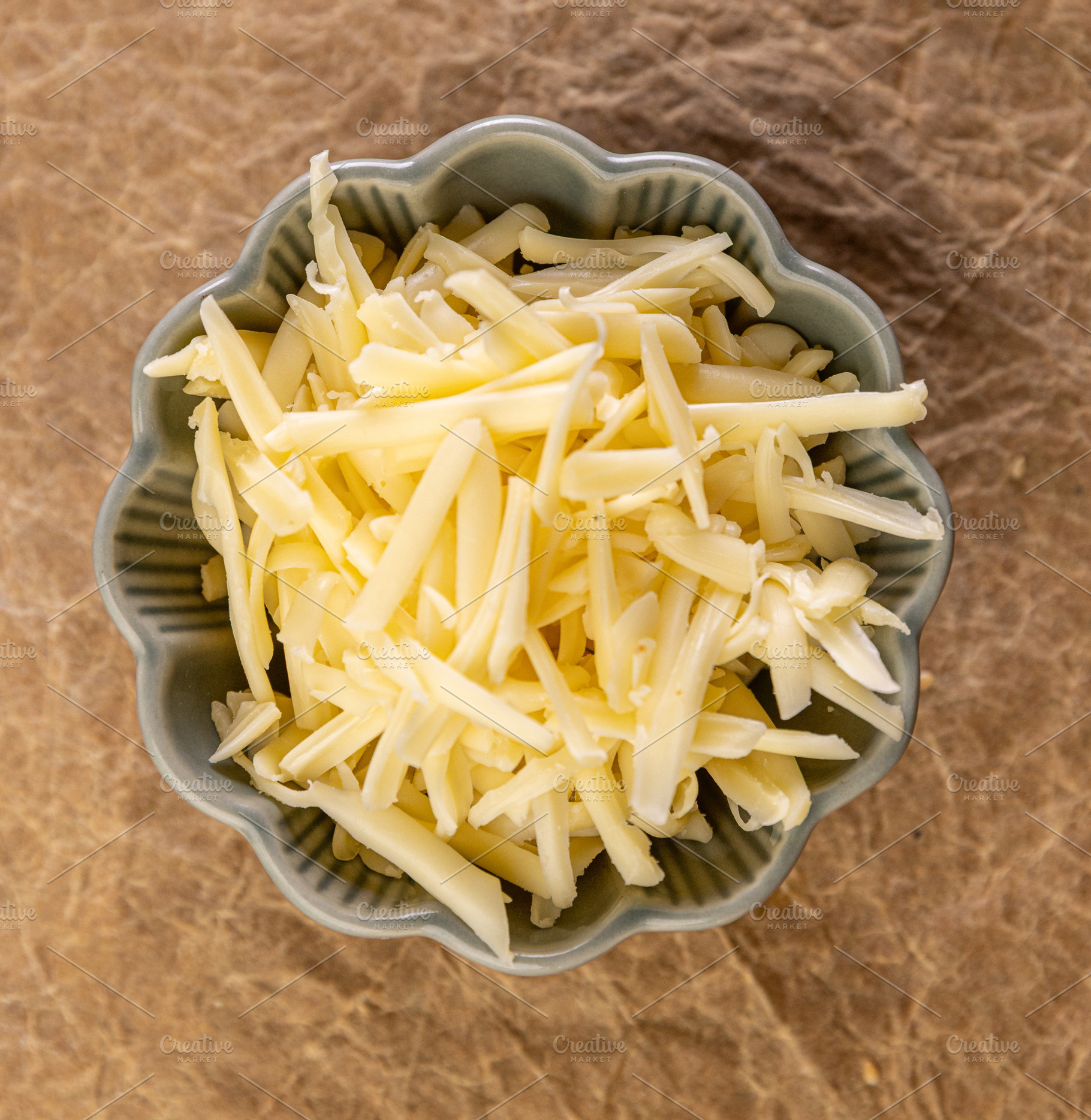 Shredded cheese waiting in a bowl, a Photo by Grafvision photography