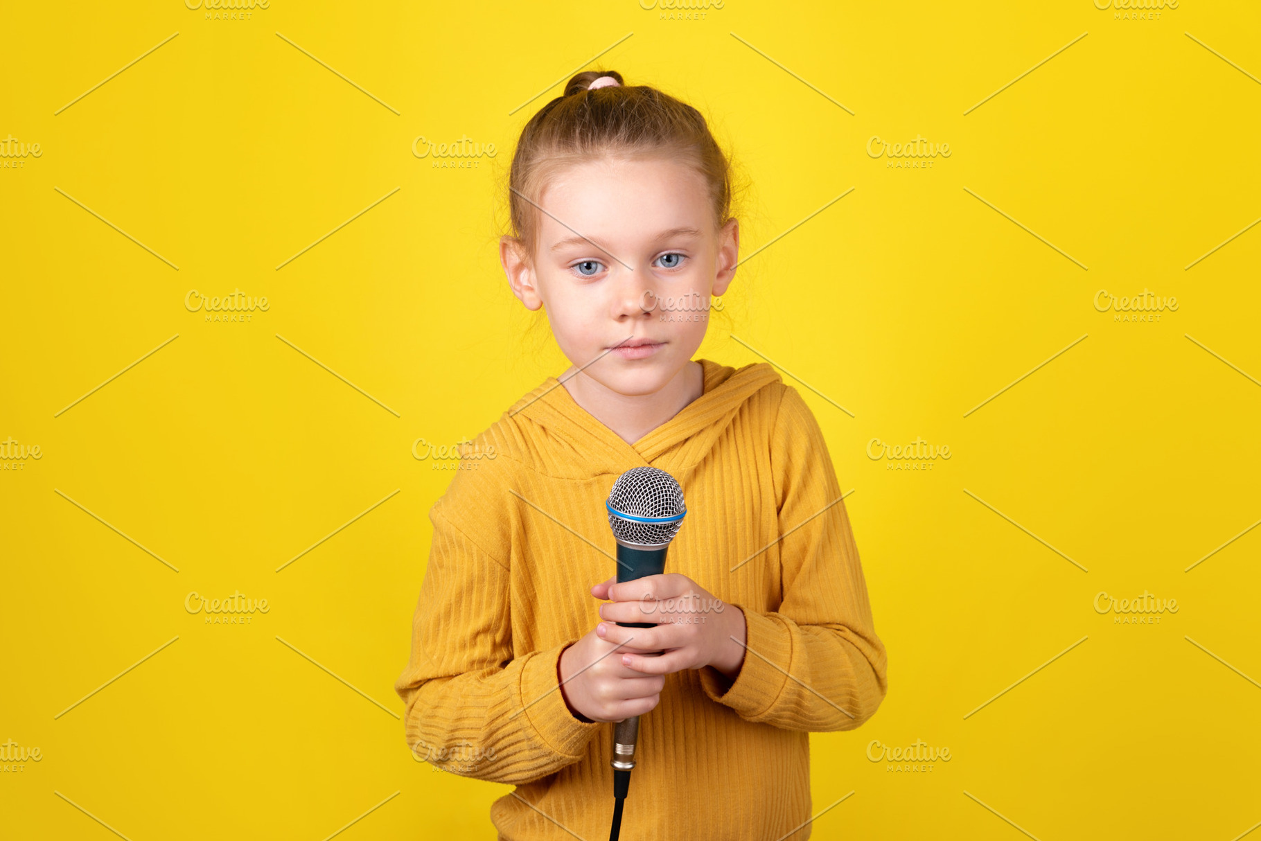 Child Holding Microphone, a Person Photo by Ales Munt