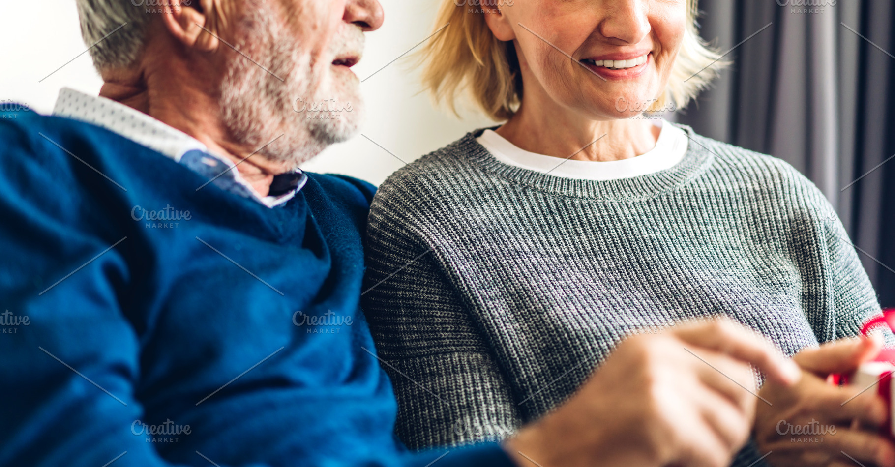 Senior couple relaxing and talking together sitting on sofa in l, a Person Photo by Art_Photo