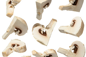 Slice of raw white champignon on isolated background, a Food & Drink Photo by ndanko