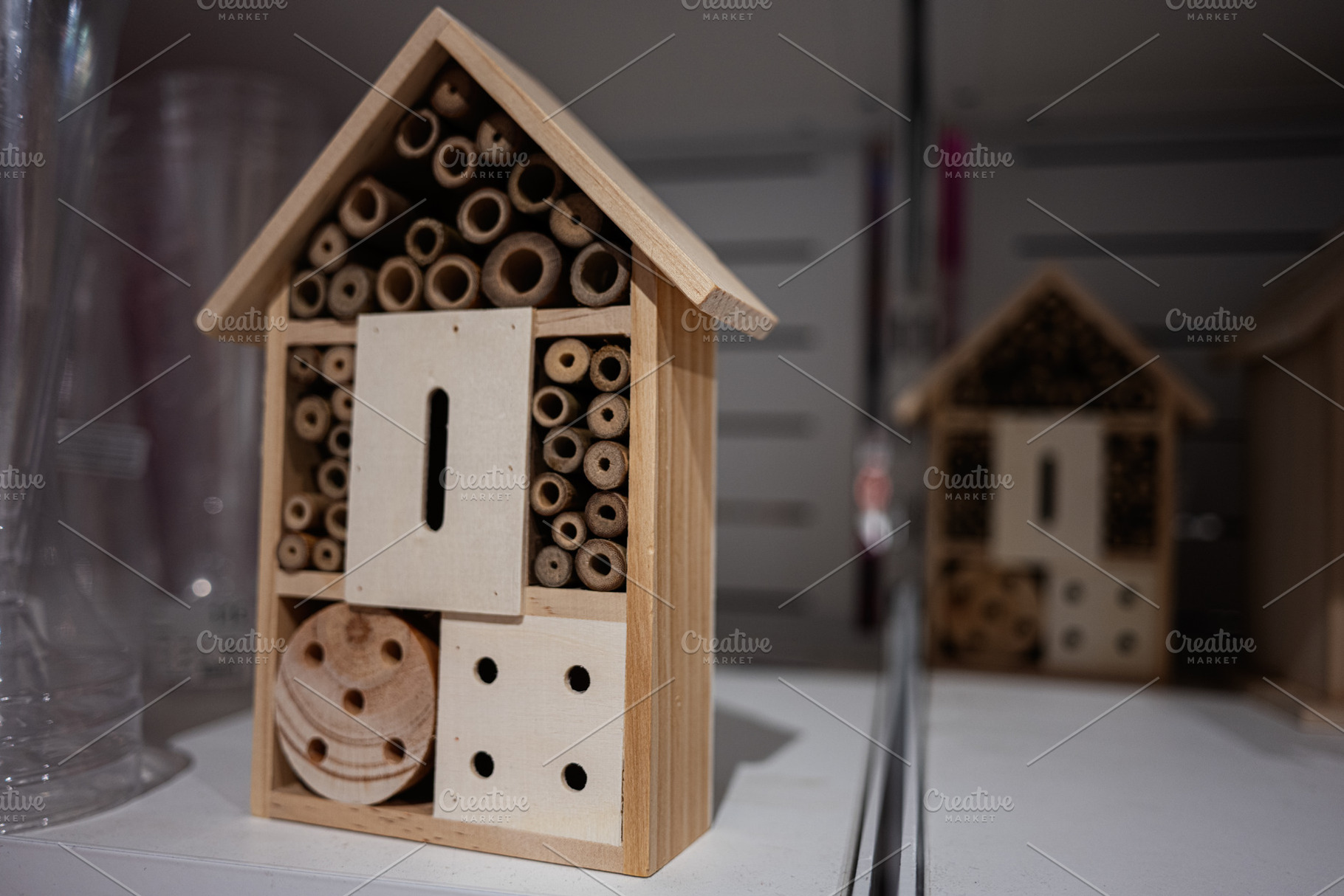 Wooden insect house on display in a store setting in close-up view, a Photo by AS photostudio