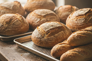 Artisan Sourdough Loaves on Rustic Bakery Table, a Food & Drink Photo by Davizro's Market
