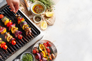 Summer BBQ skewers on grill with fre, a Photo by Dvoevnore photos