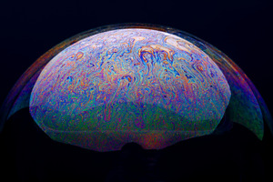 Vivid close-up of a soap bubble surface, showcasing swirling rai, an Abstract Photo by Ales Munt