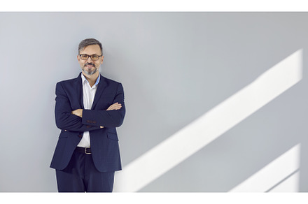 Happy handsome businessman in a dark, a Person Photo by StudioRomantic