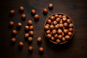 Whole hazelnuts in a wooden bowl wit, a Food & Drink Photo by professorinc