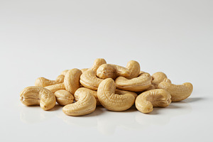 Heap of raw cashew nuts on a clean w, a Food & Drink Photo by professorinc