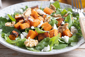 Pumpkin salad with arugula, walnuts and feta cheese on wooden ta, a Food & Drink Photo by etorres69