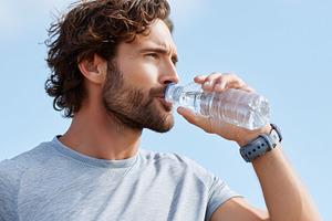 Young man drinking water from bottle, a Food & Drink Photo by MistyDay