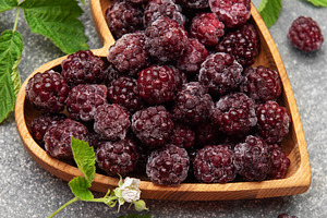 Frozen blackberries in heart shaped wooden bowl, a Food & Drink Photo by Olena Rudo