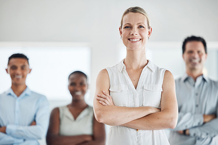 Team success, proud business woman and leader with a smile in a office with staff. Portrait of a corporate company ceo and manager happy about teamwork, work management and staff leadership growth, a Photo by Peopleimages.com