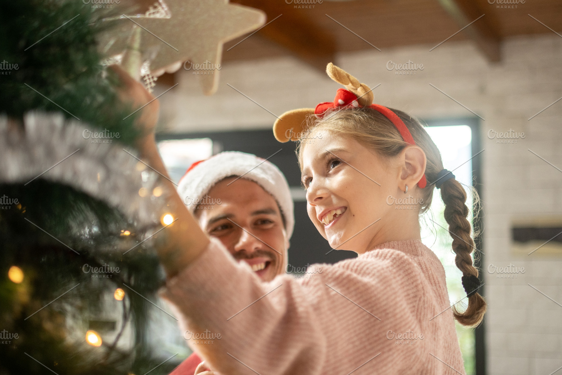 Father and daughter decorating Christmas tree together, a Person Photo by etorres69