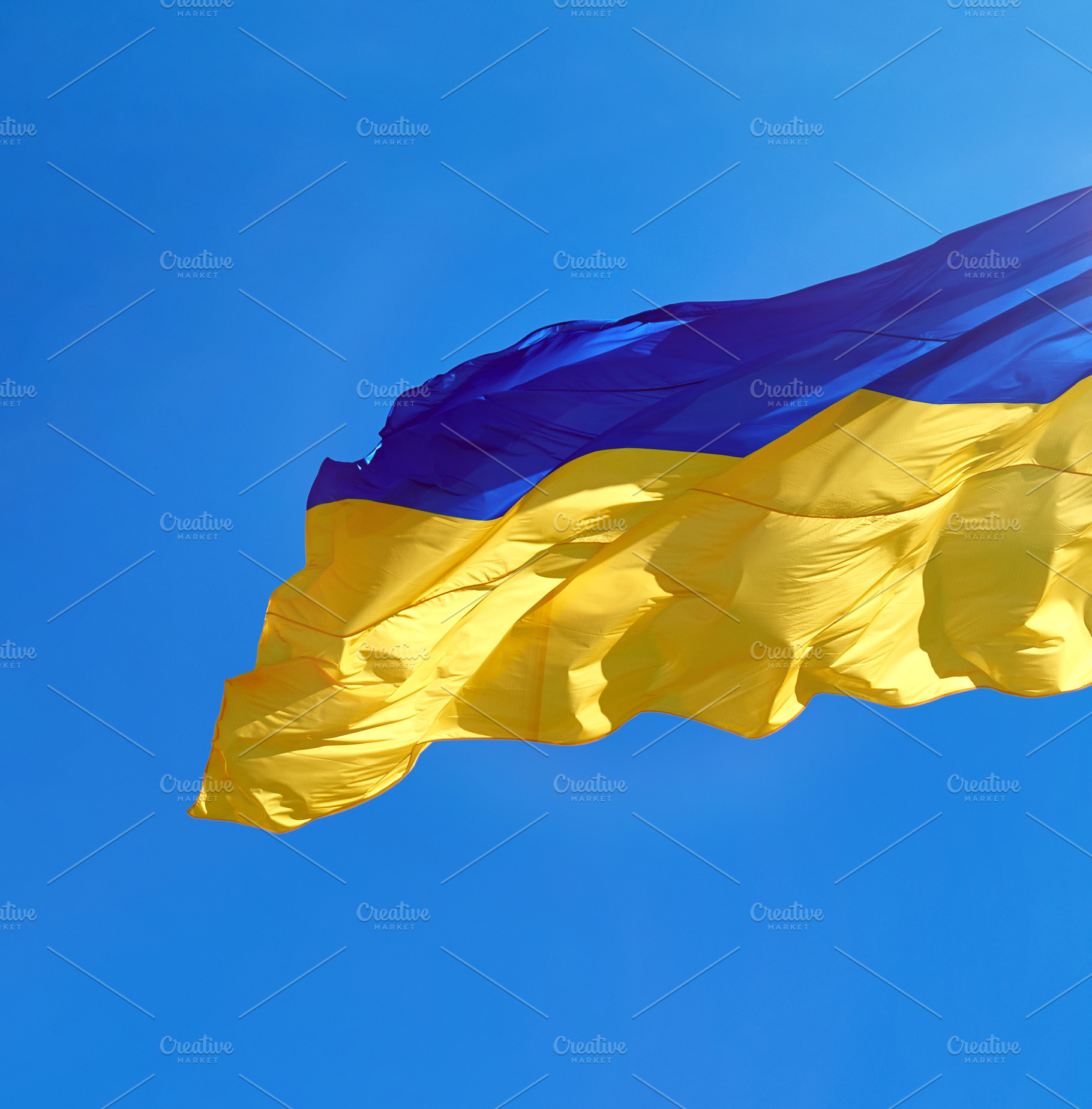 The national flag of Ukraine against a clear blue sky, an Abstract Photo by ndanko