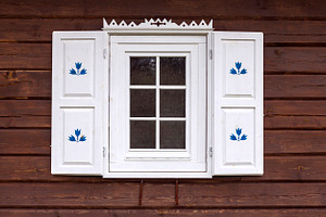 Log house with decorated window, an Architecture Photo by BOOCYS
