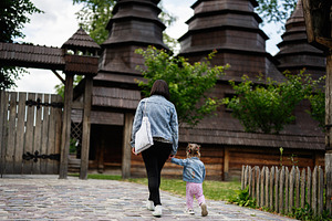 Mother and child exploring traditional wooden architecture in a serene garden s, a Person Photo by AS photostudio