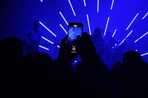 Live band on stage with radial light beams, an Arts & Entertainment Photo by DanFLCreativo