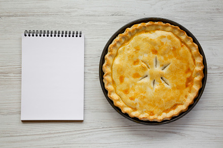 A Piece of Chicken Pot Pie, blank notepad on a white wooden surf, a Food & Drink Photo by LiudmylaChuhunova