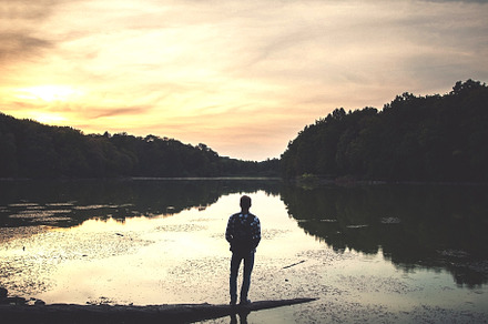 Tourist on the lake with forest.