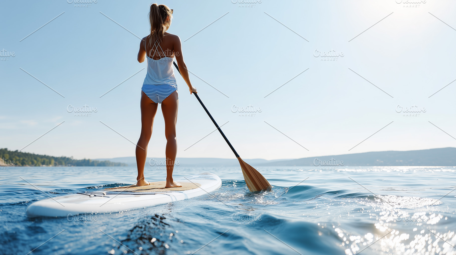 Young woman in a swimsuit enjoys sup, a Sports & Recreation Photo by MistyDay