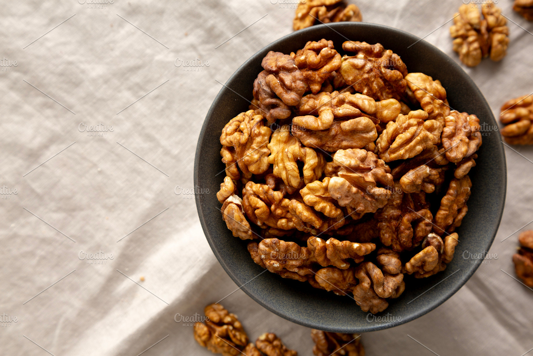 Raw Walnut Halfs in a Bowl, top view. Flat lay, overhead. Copy s, a Food & Drink Photo by LiudmylaChuhunova