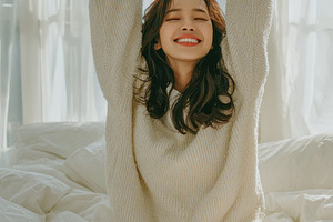 Woman waking up in bed stretching in, a Photo by Pixeness Studio
