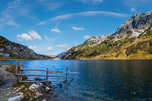 Sunny autumn alpine Tappenkarsee lake and rocky mountains above,, a Nature Photo by YuriyB