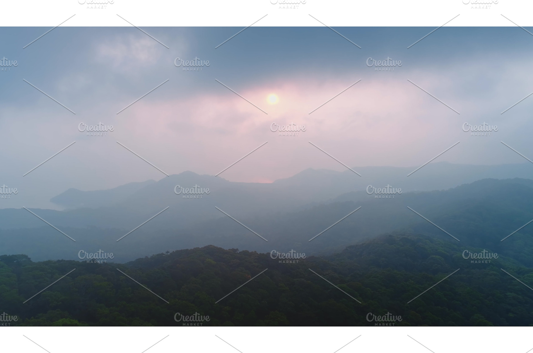 Sun setting behind misty mountains, a Nature Photo by Goinyk