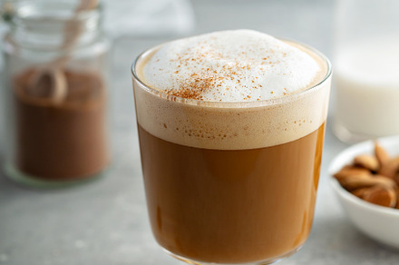 Almond milk latte in a glass, a Food & Drink Photo by farwasser