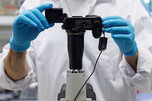 Technician connects digital camera t, a Health & Medical Photo by Perpis