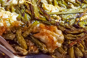 Grilled green beans with melted cheese in black bowl, a Food & Drink Photo by DanFLCreativo