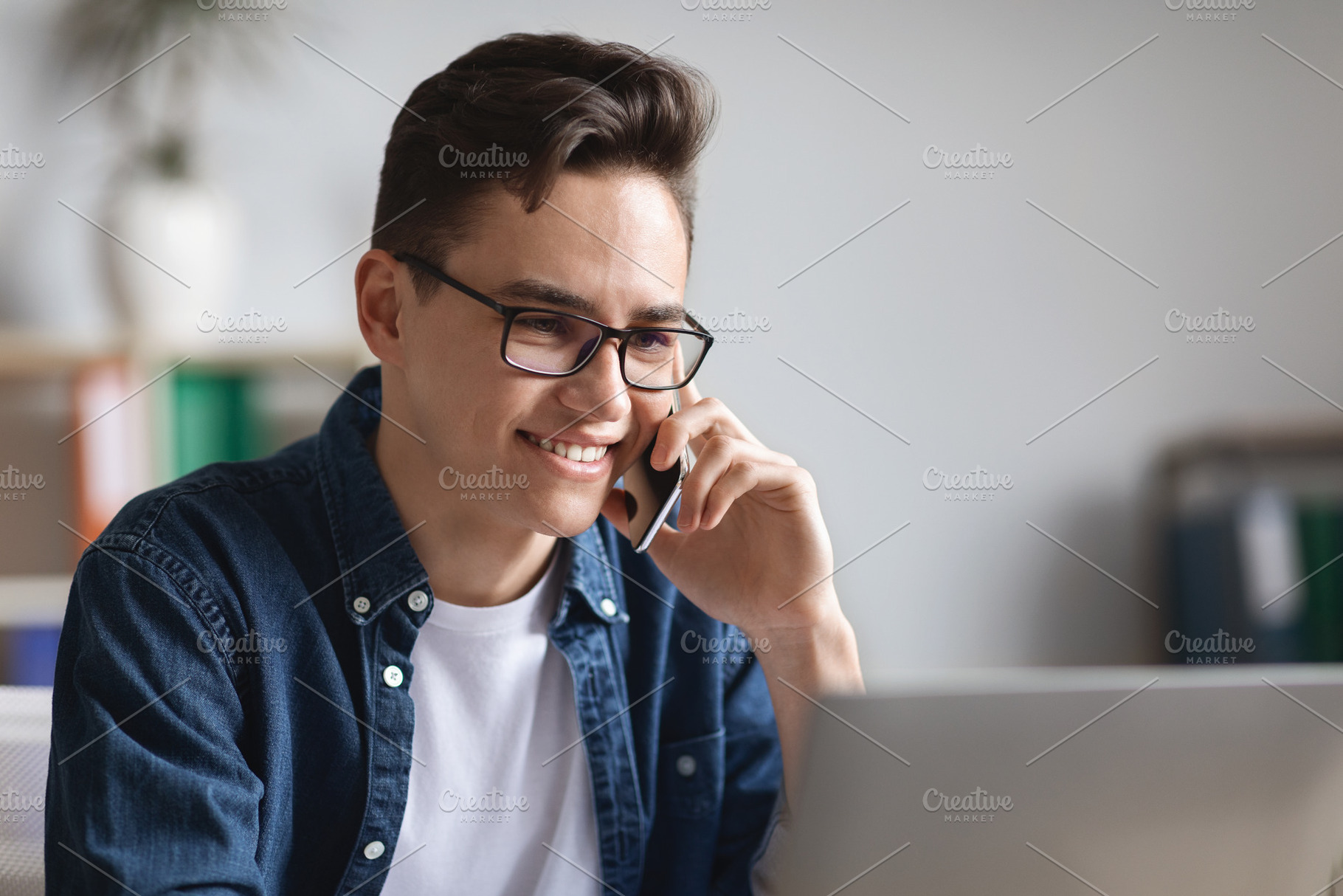 Business Conversation. Young Manager Talking On Cellphone And Using Laptop In O, a Photo by Prostock-Studio