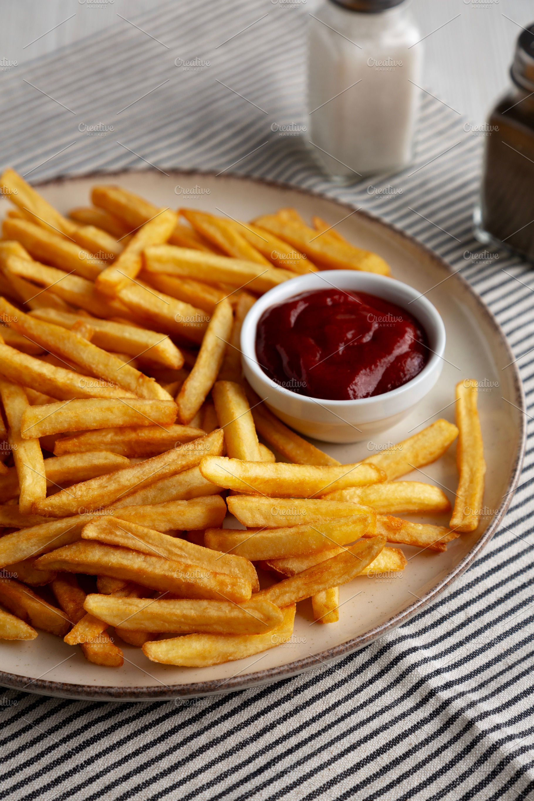 Homemade Golden French Fries with Ketchup, side view., a Food & Drink Photo by LiudmylaChuhunova