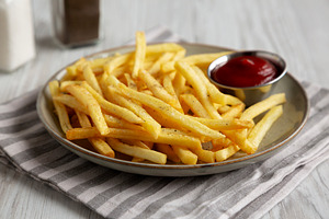 Homemade French Fries and Ketchup on a Plate, side view. Close-u, a Food & Drink Photo by LiudmylaChuhunova