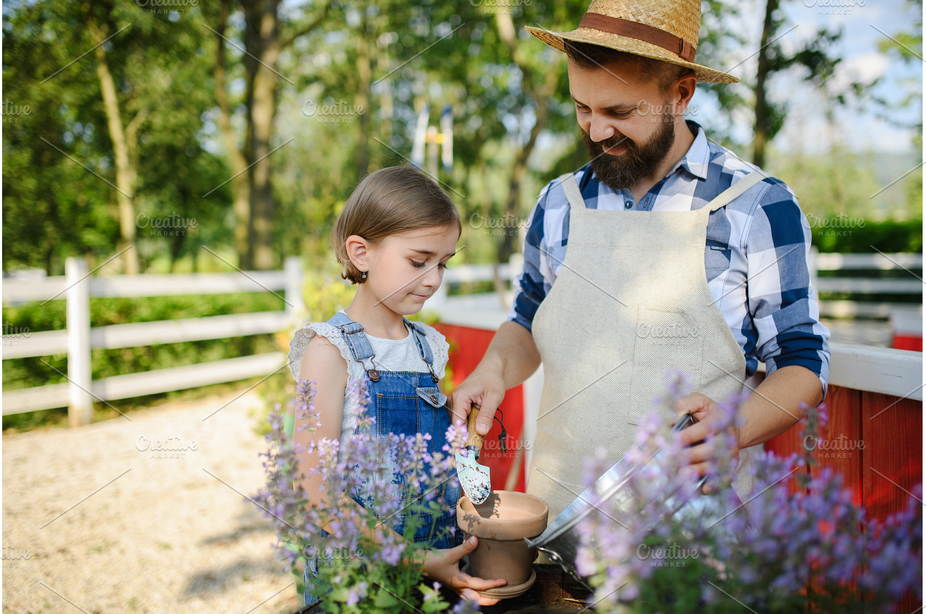 Father and young daughter planting, a Nature Photo by HalfPoint