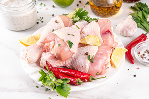 Fresh raw organic chicken legs, drumsticks, with spices and cond, a Food & Drink Photo by Rimma