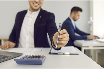 Male agent sitting at office desk, a Business Photo by StudioRomantic