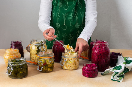 Woman fermenting fresh vegetables, a Food & Drink Photo by Pandateam