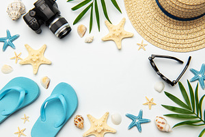Summer accessories creating a frame on white background with cop, a Holiday Photo by Olena Rudo