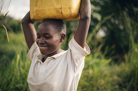 African Girl Carries Water Jerrycan