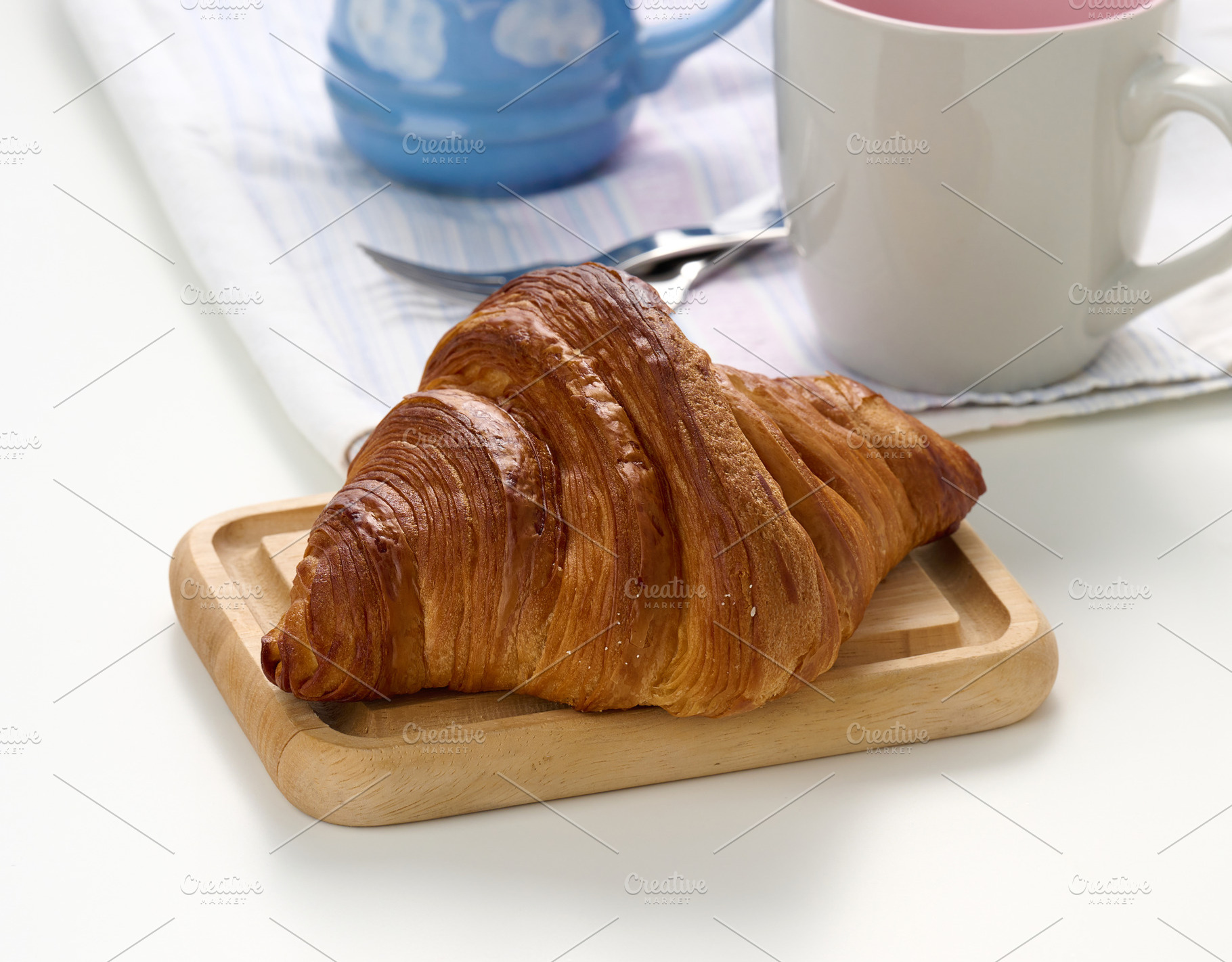 Fresh croissant on a white background., a Food & Drink Photo by ndanko