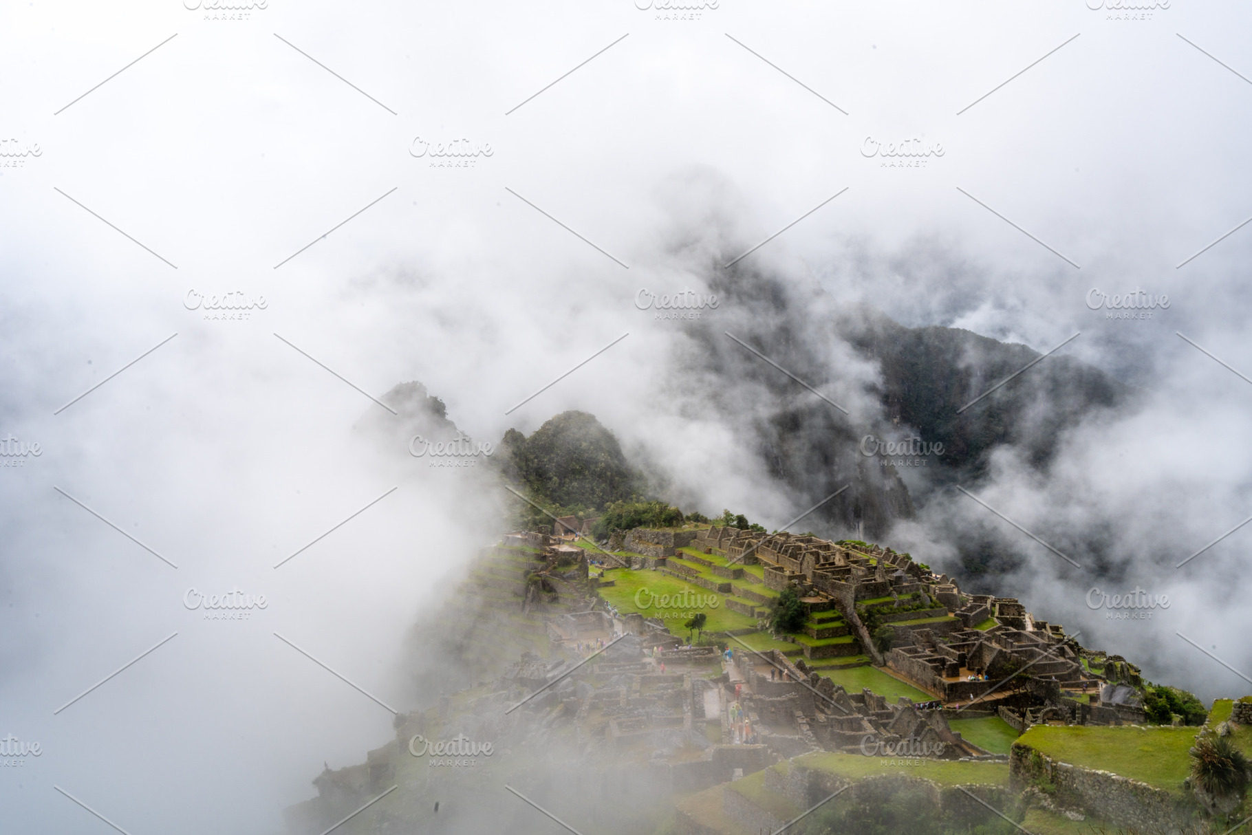 Panoramic view of Machu Picchu ruins surrounded by misty mountai, an Architecture Photo by GoodGoods