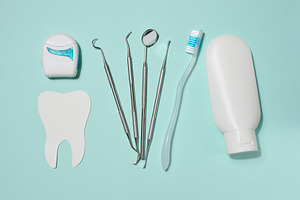 White tube of toothpaste, dental floss in white case, dental ins, a Health & Medical Photo by ndanko