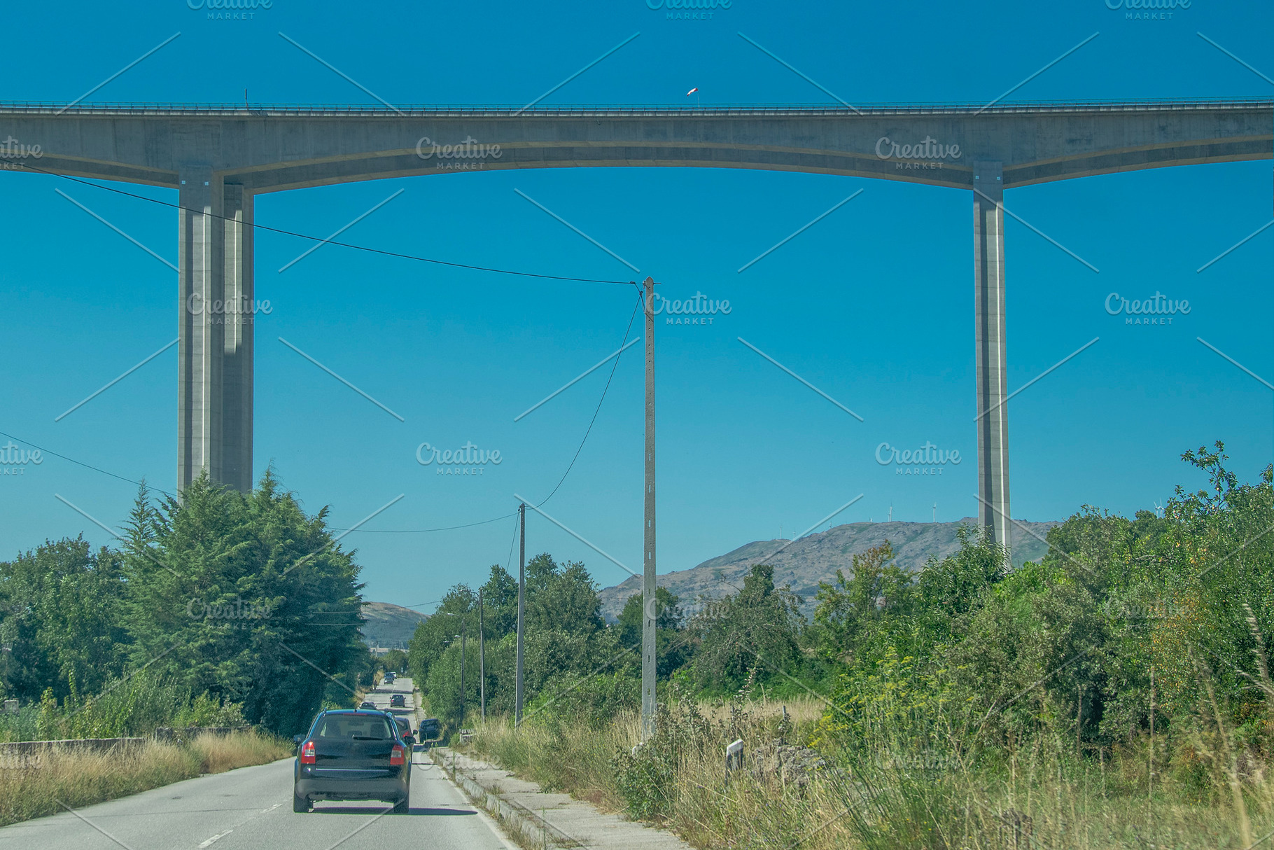 Concrete viaduct bridge crossing forest landscape, a Transportation Photo by DanFLCreativo