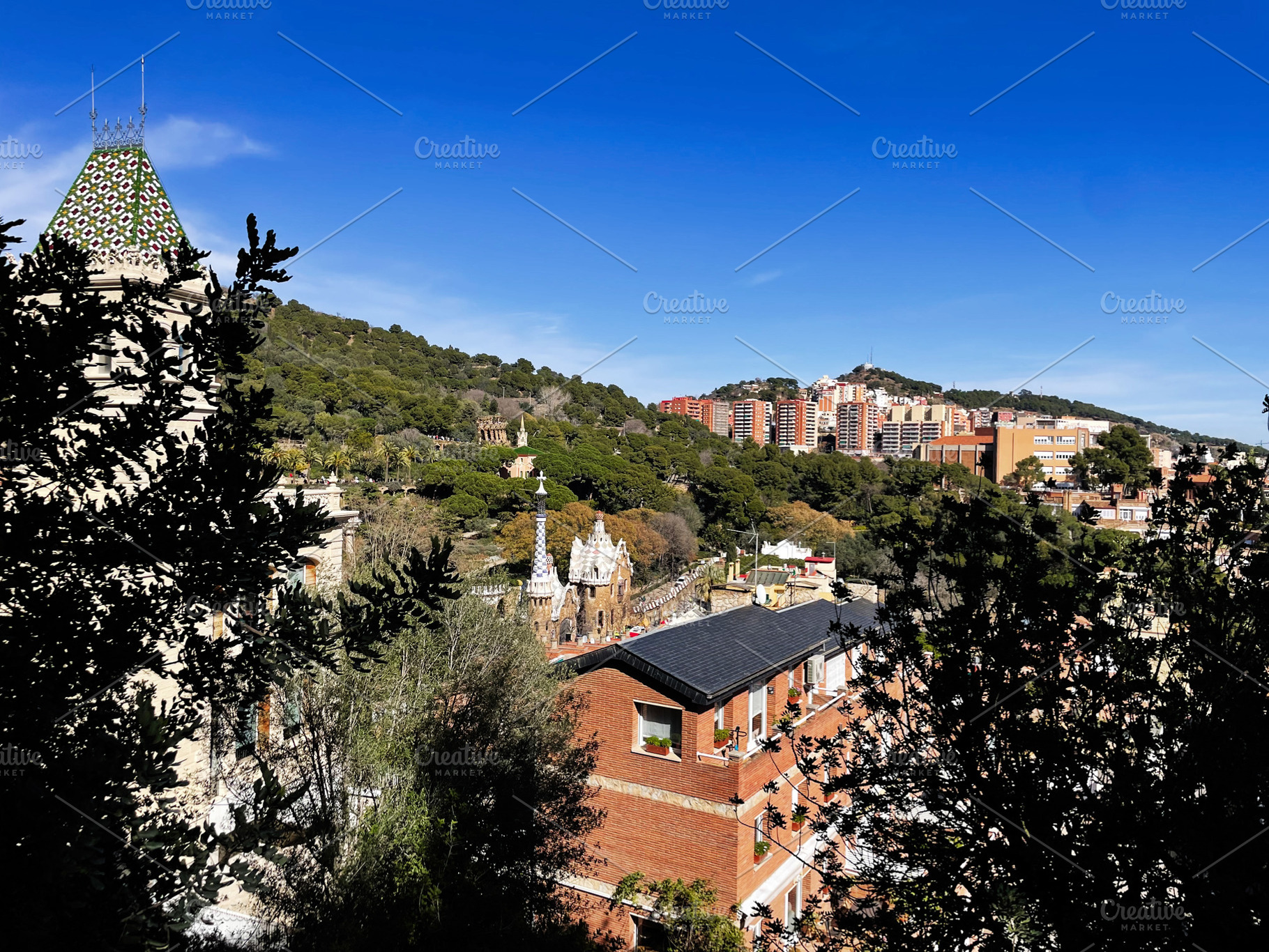 Scenic view of Park Guell in Barcelona Spain under a clear blue sky, a Photo by AS photostudio