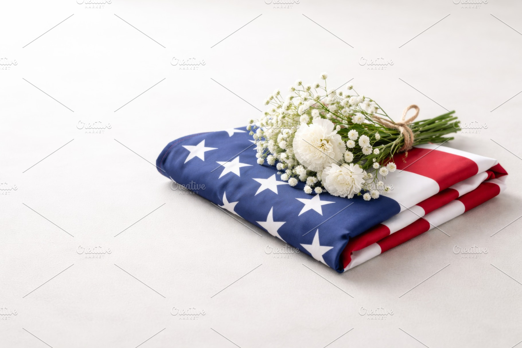 Folded American flag with flowers sy, a Photo by Dvoevnore photos